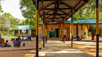 Outside the female ward at the IRC’s Hagadera Refugee Camp Hospital, Kenya (part of the Dadaab complex). Families of patients walk out during visiting hours.